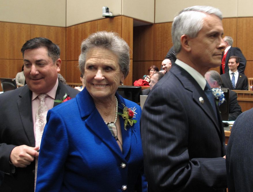 FILE - In this Jan. 15, 2013, file photo, state Sen. Mary Kay Papen, D-Las Cruces, center, lines up to take her oath of office in Santa Fe, N.M. Money is being stockpiled by leading state legislators under specialized political committees that can collect five-times as much cash per donor as standard campaigns and committees. Six-month campaign finance disclosure reports are due by Tuesday evening as Democrats defend their majority in the state House and Senate. (AP Photo/Russell Contreras, File)