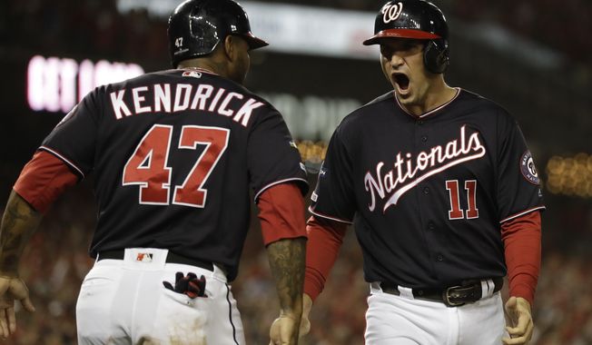 Washington Nationals&#x27; Ryan Zimmerman reacts with Howie Kendrick after scoring during the first inning of Game 4 of the baseball National League Championship Series against the St. Louis Cardinals Tuesday, Oct. 15, 2019, in Washington. (AP Photo/Jeff Roberson)