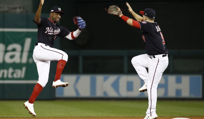 Washington Nationals&#x27; Victor Robles and Brian Dozier celebrate after Game 3 of the baseball National League Championship Series against the St. Louis Cardinals Monday, Oct. 14, 2019, in Washington. The Nationals won 8-1 to take a 3-0 lead in the series. (AP Photo/Patrick Semansky) ** FILE **