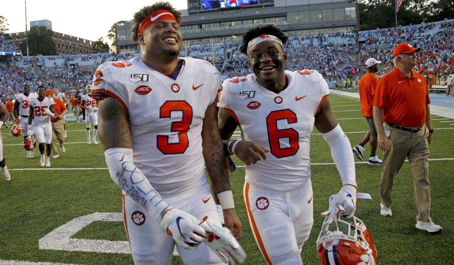 FILE - In this Sept. 28, 2019, file photo, Clemson's Xavier Thomas (3) and Mike Jones Jr. (6) celebrate after a failed North Carolina two-point conversion in the closing moments of an NCAA college football game in Chapel Hill, N.C. Clemson nearly saw a 19-game win streak end when North Carolina pushed the Tigers to the brink. (AP Photo/Chris Seward, File)