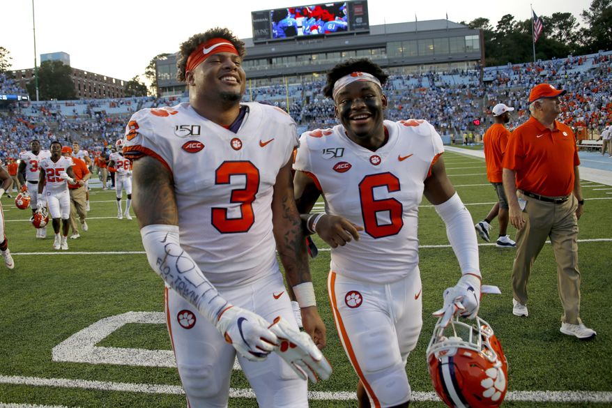 FILE - In this Sept. 28, 2019, file photo, Clemson's Xavier Thomas (3) and Mike Jones Jr. (6) celebrate after a failed North Carolina two-point conversion in the closing moments of an NCAA college football game in Chapel Hill, N.C. Clemson nearly saw a 19-game win streak end when North Carolina pushed the Tigers to the brink. (AP Photo/Chris Seward, File)