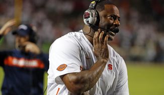 Syracuse coach Dino Babers watches a replay on the scoreboard during the second half of the team&#39;s NCAA college football game against North Carolina State in Raleigh, N.C., Thursday, Oct. 10, 2019. (AP Photo/Karl B DeBlaker)