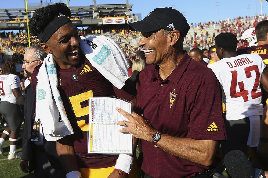 Arizona State quarterback Jayden Daniels (5) celebrates with head coach Herm Edwards, right, after an NCAA college football game win over Washington State, Saturday, Oct. 12, 2019, in Tempe, Ariz. (AP Photo/Ross D. Franklin)