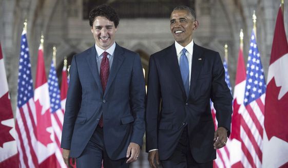 FILE - In this June 29, 2016, file photo, U.S. President Barack Obama and Canada Prime Minister Justin Trudeau walk down the Hall of Honour on Parliament Hill in Ottawa,. In a message on Twitter, Wednesday, Oct. 16, 2019, Obama says the world needs progressive leadership and he hopes Canadians will give Trudeau another term as prime minister. (Paul Chiasson/The Canadian Press via AP, File)
