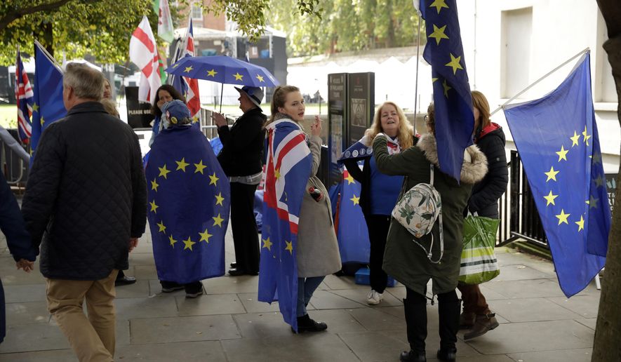 Anti-Brexit remain in the European Union supporters protest across the street from the Houses of Parliament in London, Tuesday, Oct. 15, 2019. A Brexit divorce deal is still possible ahead of Thursday&#39;s European Union summit but the British government needs to move ahead with more compromises to seal an agreement in the next few hours, the bloc said Tuesday. (AP Photo/Matt Dunham)