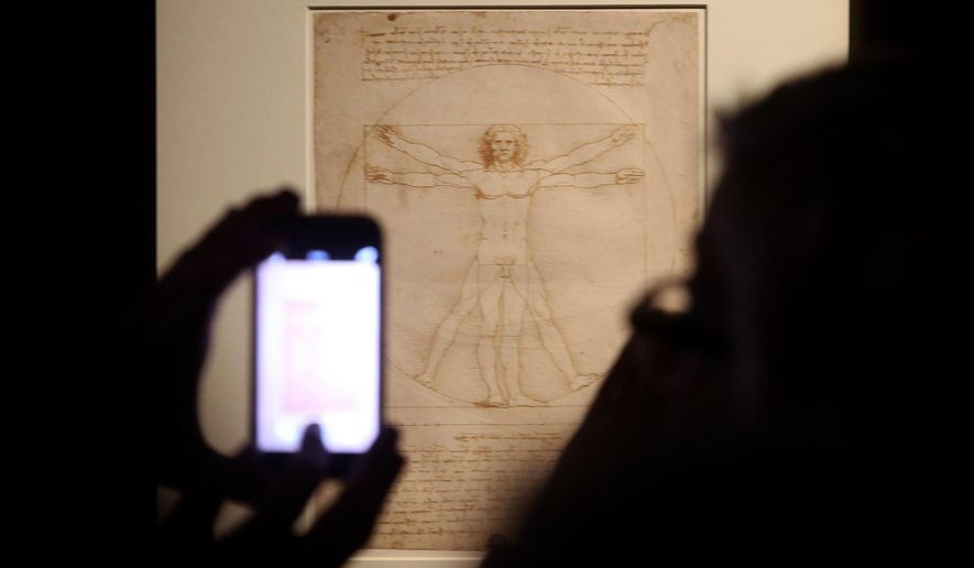 FILE - In this Tuesday April 14, 2015 file photo, Leonardo da Vinci&#x27;s &amp;quot;Vitruvian Man&amp;quot; is displayed during an exhibition in Milan, Italy. An Italian court has ruled that Leonardo Da Vinci&#x27;s iconic Vitruvian Man drawing can be loaned to France&#x27;s Louvre, solving a long-going cultural dispute between Italy and France. The Venice court last week had suspended the loan of the world-famous drawing, which is part of a batch of works by Leonardo and Raphael that the Italian government had agreed to send to Paris. Wednesday’s ruling cleared the way to the loan, rejecting a complaint filed by an Italian heritage group, Italia Nostra (Our Italy), which contended that the drawing was too fragile to travel and risked being damaged. (Matteo Bazzi/ANSA via AP)