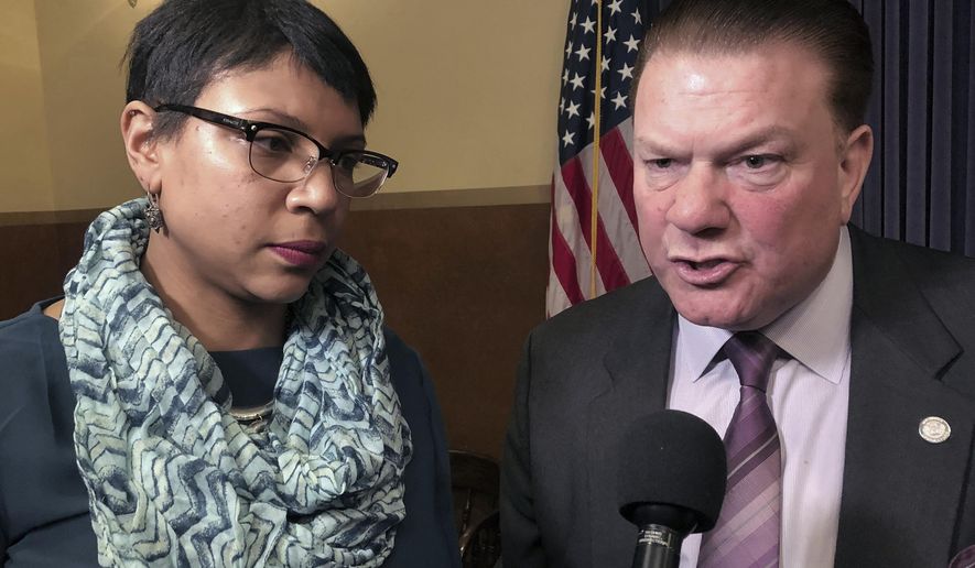 FILE - In this Feb. 20, 2019 file photo, State Sens. Sylvia Santana, D-Detroit, and Peter Lucido, R-Shelby Township, speak with reporters after a news conference at the Capitol in Lansing, Mich. State lawmakers are close to ending Michigan's status as one of the few states where 17-year-old offenders are automatically prosecuted as adults. The state Senate overwhelmingly approved bills Wednesday, Oct. 16, 2019, a day after the House voted. Starting in October 2021, Michigan's age at which defendants are considered adults would be 18 instead of 17. Prosecutors could still try 14-, 15-, 16- and 17-year-olds as adults for certain violent offenses, such as murder and rape. Santana and Lucido were sponsors of the bill. (AP Photo/David Eggert File)