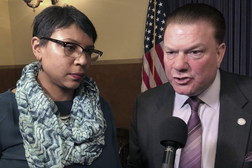 FILE - In this Feb. 20, 2019 file photo, State Sens. Sylvia Santana, D-Detroit, and Peter Lucido, R-Shelby Township, speak with reporters after a news conference at the Capitol in Lansing, Mich. State lawmakers are close to ending Michigan's status as one of the few states where 17-year-old offenders are automatically prosecuted as adults. The state Senate overwhelmingly approved bills Wednesday, Oct. 16, 2019, a day after the House voted. Starting in October 2021, Michigan's age at which defendants are considered adults would be 18 instead of 17. Prosecutors could still try 14-, 15-, 16- and 17-year-olds as adults for certain violent offenses, such as murder and rape. Santana and Lucido were sponsors of the bill. (AP Photo/David Eggert File)