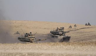 Turkish tanks and troops stationed near Syrian town of Manbij, Syria, Tuesday. Oct. 15, 2019. Russia moved to fill the void left by the United States in northern Syria on Tuesday, deploying troops to keep apart advancing Syrian government and Turkish forces.(Ugur Can/DHA via AP)