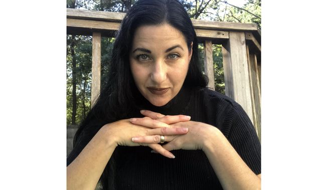 This Oct. 2019 photo provided by Alexandra Holzer shows Holzer at her home to promote her new Travel Channel series, “The Holzer Files,” airing Thursday at 10 p.m. EDT. (Alexandra Holzer via AP)