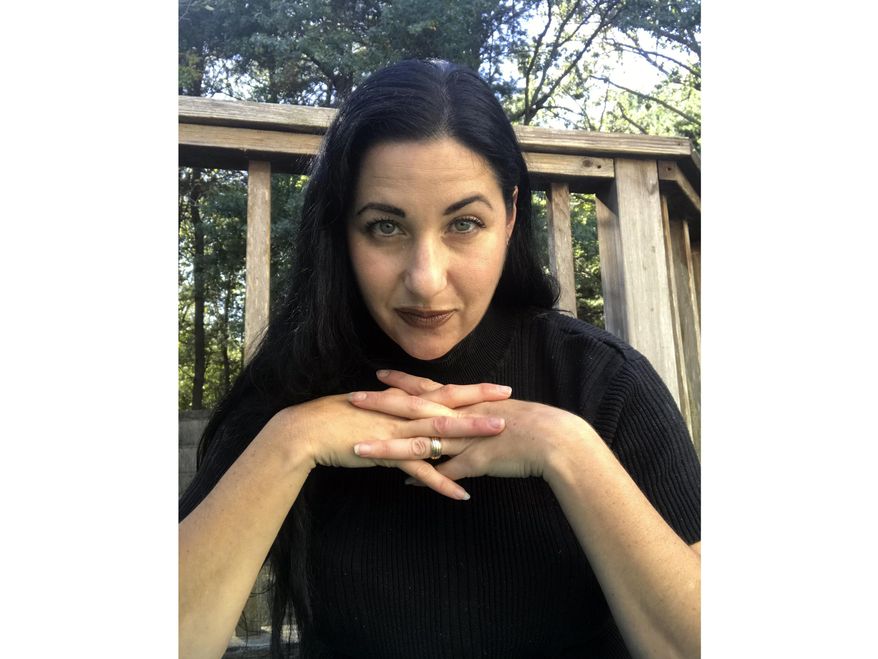 This Oct. 2019 photo provided by Alexandra Holzer shows Holzer at her home to promote her new Travel Channel series, “The Holzer Files,” airing Thursday at 10 p.m. EDT. (Alexandra Holzer via AP)