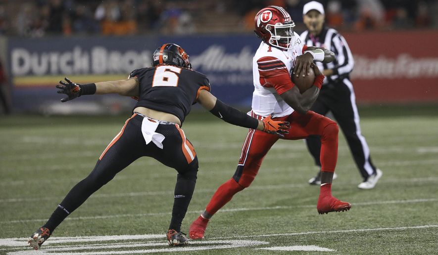 Utah quarterback Tyler Huntley (1) dodges Oregon State outside linebacker John McCartan (6) during the second half of an NCAA college football game in Corvallis, Ore., Saturday, Oct. 12, 2019. Utah won 52-7. (AP Photo/Amanda Loman)