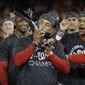 Washington Nationals manager Dave Martinez kisses the NLCS trophy after Game 4 of the baseball National League Championship Series against the St. Louis Cardinals Tuesday, Oct. 15, 2019, in Washington. The Nationals won 7-4 to win the series 4-0. (AP Photo/Jeff Roberson) **FILE**