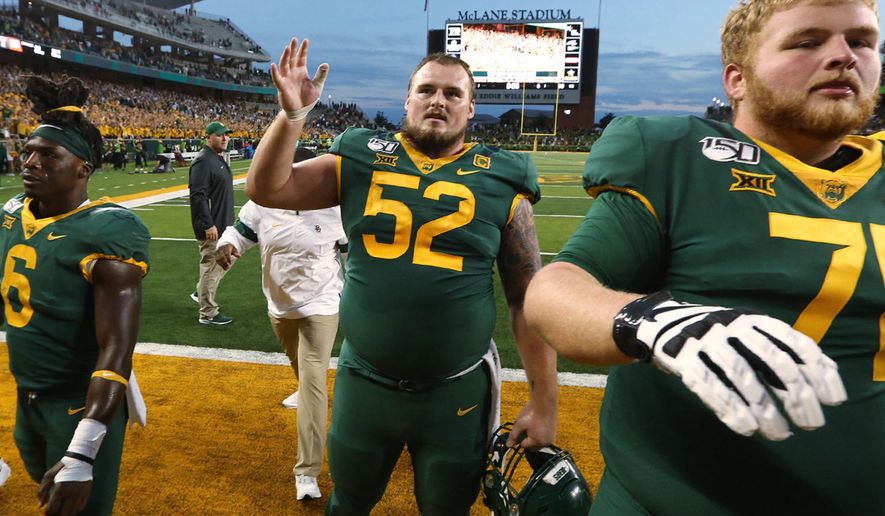 In this Saturday, Oct. 12, 2019, photo, Baylor offensive lineman Sam Tecklenburg, center, thanks the fans after the team's win over Texas Tech in an NCAA college football game in Waco, Texas. Standing next to Techlenburg are JaMycal Hasty, left, and Jim Threet, Tecklenburg is among 10 current seniors who redshirted in 2015, when Baylor was coming off back-to-back Big 12 titles and had its last eight-game winning streak. There is also sixth-year receiver Chris Platt, who was playing as a redshirt that season and got an extra year of eligibility after a season-ending knee injury four games in the 2017 season. They all stayed in the aftermath of a sprawling sexual assault scandal that led to coach Art Briles getting fired before the 2016 season. (Rod Aydelotte/Waco Tribune-Herald via AP)