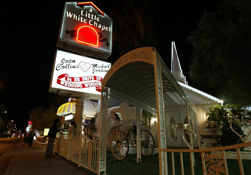FILE - In this Jan. 3, 2004 file photo, people stand near A Little White Chapel on Las Vegas Boulevard in Las Vegas. The owner of the chapel where celebrity couples like Joe Jonas and Sophie Turner have gotten married is staying wedded to her business. Charlotte Richards told KVVU-TV on Wednesday, Oct. 16, 2019, that she is taking A Little White Wedding Chapel off the market. The iconic property was listed for $12 million back in April. (AP Photo/Joe Cavaretta, File)