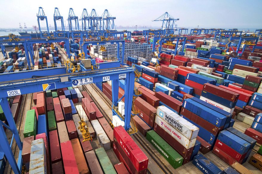 In this May 14, 2019, file photo, containers are piled up at a port in Qingdao in east China's Shandong province. (Chinatopix via AP, File)