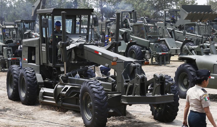 In this April 29, 2019 file photo, construction equipment stands on a field ready to move during the launch of the construction of Mexico City&#x27;s new airport at the Military Airbase Number 1 in Santa Lucia, on the outskirts of Mexico City. Mexico has broken ground on Thursday, Oct. 17, on the project to supplement the capital’s overtaxed international airport, an alternative to another one that was scrapped last year after being about a third built. (AP Photo/Marco Ugarte, File) **FILE**