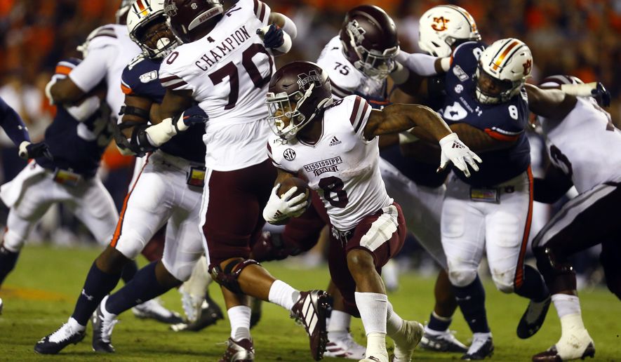 FILE - In this Sept. 28, 2019, file photo, Mississippi State running back Kylin Hill (8) carries the ball during the second half of an NCAA college football game against Auburn, in Auburn, Ala. Mississippi State’s lack of a consistent passing attack is starting to hamper star running back Kylin Hill as opposing defenses focus on stopping the ground game. After rushing for over 100 yards in each of his first four games this year, Hill has been held below 50 yards in each of Mississippi State’s last two games. Next up is No. 2 LSU (6-0, 2-0 SEC), which has the SEC’s second-ranked run defense. (AP Photo/Butch Dill, File)