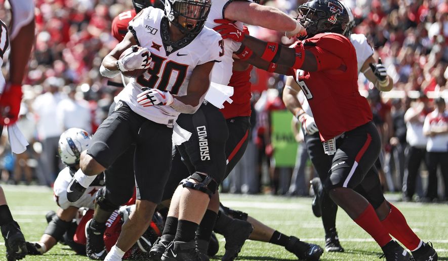 Oklahoma State's Chuba Hubbard (30) scores a touchdown during the second half of an NCAA college football game against Texas Tech, Saturday, Oct. 5, 2019, in Lubbock, Texas. (AP Photo/Brad Tollefson)