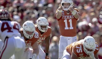 Texas quarterback Sam Ehlinger (11) directs his team against Oklahoma during the first half of an NCAA college football game at the Cotton Bowl, Saturday, Oct. 12, 2019, in Dallas. (Nick Wagner/Austin American-Statesman via AP) ** FILE **