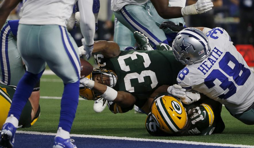Green Bay Packers running back Aaron Jones (33) reaches over Jake Kumerow (16) and Dallas Cowboys&#39; Jeff Heath (38) into the end zone for a touchdown in the second half of an NFL football game in Arlington, Texas, Sunday, Oct. 6, 2019. (AP Photo/Michael Ainsworth)