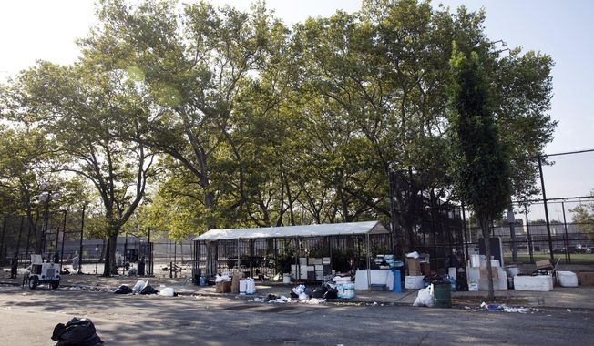 FILE - In this July 28, 2019 file photo, the remains of a party litter a playground after a shooting in the Brownsville neighborhood in the Brooklyn borough of New York. New York City police have made an arrest in the community festival shooting that left one person dead and 11 wounded this summer. Police said Wednesday, Oct. 16, that 20-year-old Kyle Williams, of Brooklyn, was arrested on murder, criminal possession of a weapon, reckless endangerment and attempted murder charges. (AP Photo/Mark Lennihan, File)