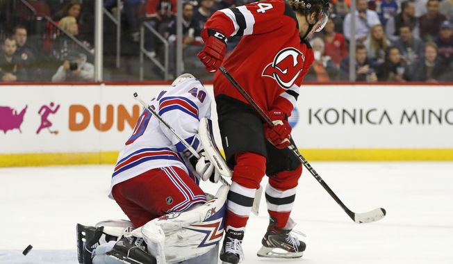 New Jersey Devils left wing Miles Wood (44) scores a goal on New York Rangers goaltender Alexandar Georgiev (40) during the second period of an NHL hockey game Thursday, Oct. 17, 2019, in Newark, N.J. (AP Photo/Kathy Willens)