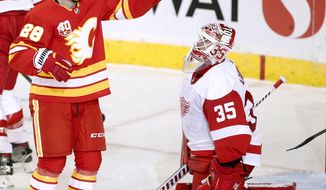 Calgary Flames center Elias Lindholm (28) celebrates his goal in front of Detroit Red Wings goalie Jimmy Howard (35) during second-period NHL hockey action in Calgary, Alberta, Thursday, Oct. 17, 2019.  (Larry MacDougal/The Canadian Press via AP)