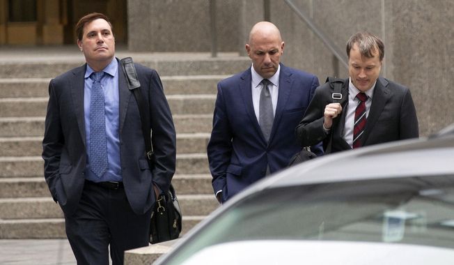 David Correia, center, arrives with his lawyers at federal court, Thursday, Oct. 17, 2019, in New York. Correia and Andrey Kukushkin were set to be arraigned Thursday on charges they conspired with associates of Rudy Giuliani to make illegal campaign contributions. (AP Photo/Kevin Hagen).