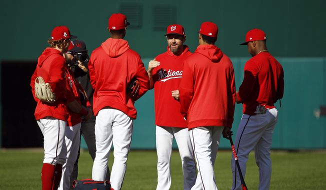 Washington Nationals third base coach Bob Henley, center, speaks with players during a baseball workout, Friday, Oct. 18, 2019, in Washington, in advance of the team&#x27;s appearance in the World Series. (AP Photo/Patrick Semansky) **FILE**