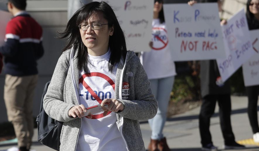 In this photo taken Oct. 11, 2019, Linda Yang, of the 'Let People Vote' campaign, is seen at a demonstration against I-1000, in Bellevue, Wash. More than two decades after Washington voters banned affirmative action, the question of whether one's minority status should be considered as a contributing factor in state employment, contracting and admission to public colleges and universities is back on the ballot. The Nov. 5 vote comes months after the Legislature approved Initiative 1000 in April, on the final day of this year's legislative session. Opponents of the measure collected enough signatures to force a referendum, Referendum 88, and now voters will have the final say on whether I-1000 should become law. (AP Photo/Elaine Thompson)