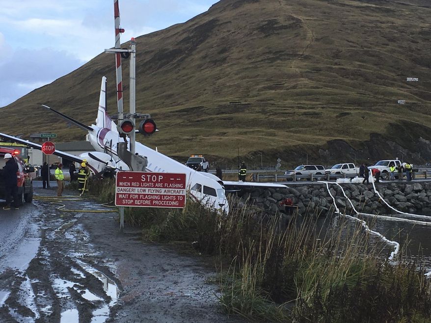 A commuter airplane has crashed near the airport in a small Alaska community on the Bering Sea, Thursday, Oct. 17, 2019, in Unalaska, Alaska. Freelance photographer Jim Paulin says the crash at the Unalaska airport occurred Thursday after 5 p.m. Paulin says the Peninsula Airways flight from Anchorage to Dutch Harbor landed about 500 feet (152 meters) beyond the airport near the water. (Jim Paulin via AP)