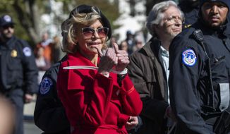 Actress Jane Fonda gestures after being arrested during a rally on Capitol Hill in Washington, Friday, Oct. 18, 2019. A half-century after throwing her attention-getting celebrity status into Vietnam War protests, Fonda is now doing the same in a U.S. climate movement where the average age is 18. (AP Photo/Manuel Balce Ceneta)