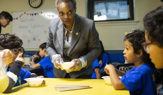 Mayor Lori Lightfoot passes out breakfast to Chicago Public Schools students at a contingency site, Gads Hill Center, Friday, Oct. 18, 2019. Striking Chicago teachers have returned to the picket lines for a second day as union and city bargainers try to hammer out a contract in the nation&#39;s third-largest school district.  (Ashlee Rezin Garcia /Chicago Sun-Times via AP)