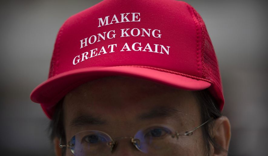 A demonstrator wears a hat reading "Make Hong Kong great again" during a rally in the Central District in Hong Kong, Friday, Oct. 18, 2019. Hundreds of demonstrators marched through the heart of Hong Kong on Friday afternoon in a "flash mob" gathering as part of continuing pro-democracy protests on the city. (AP Photo/Mark Schiefelbein)