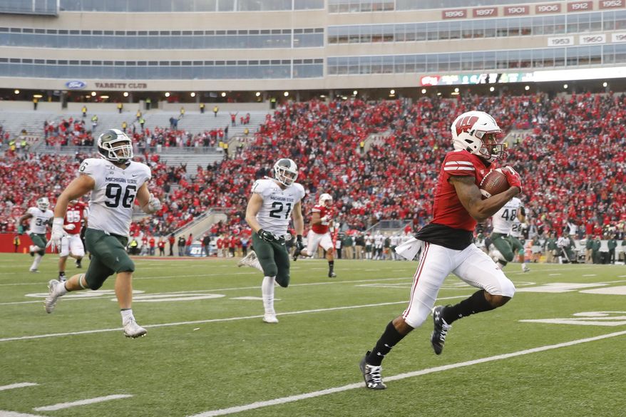 Wisconsin wide receiver Kendric Pryor (3) outruns Michigan State defensive end Jacub Panasiuk (96) and linebacker Chase Kline (21) for a reception touchdown during the second half of an NCAA college football game Saturday, Oct. 12, 2019, in Madison, Wis. Wisconsin won 38-0. (AP Photo/Andy Manis)