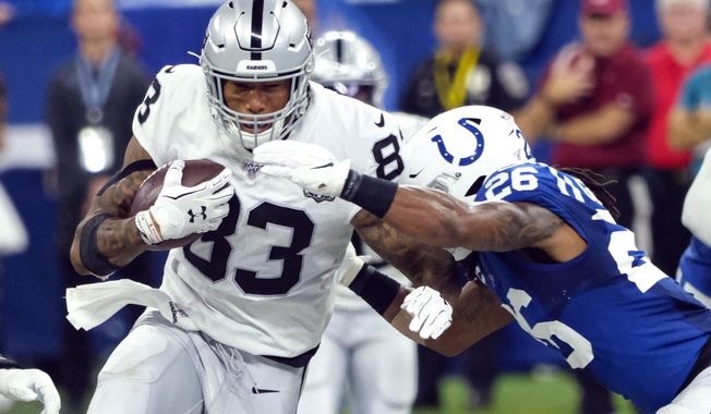 FILE - In this Sept. 29, 2019, file photo, Oakland Raiders tight end Darren Waller (83) tries to fend off Indianapolis Colts strong safety Clayton Geathers (26) during the first half of an NFL football game in Indianapolis. When Waller signed a multiyear contract extension worth a reported $9 million a season, he couldn&#x27;t help but reflect on the journey he&#x27;s been on since signing a deal in that same office a year ago to join the Raiders from Baltimore&#x27;s practice squad. (AP Photo/AJ Mast, File)