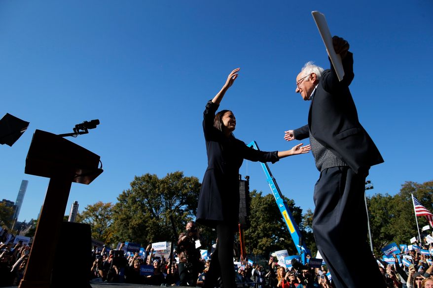 Democratic presidential candidate Sen. Bernie Sanders, I-Vt., hugs Rep. Alexandria Ocasio-Cortez, D-N.Y. during a campaign rally on Saturday, Oct. 19, 2019 in New York. (AP Photo/Eduardo Munoz Alvarez)