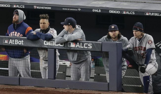 The Houston Astros watch play from the dugout during the ninth inning of Game 5 of baseball&#x27;s American League Championship Series against the New York Yankees, Friday, Oct. 18, 2019, in New York. The Yankees won 4-1. (AP Photo/Seth Wenig)