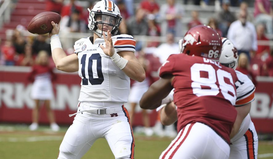 Auburn quarterback Bo Nix throws a pass against Arkansas during the first half of an NCAA college football game, Saturday, Oct. 19, 2019 in Fayetteville, Ark. (AP Photo/Michael Woods)