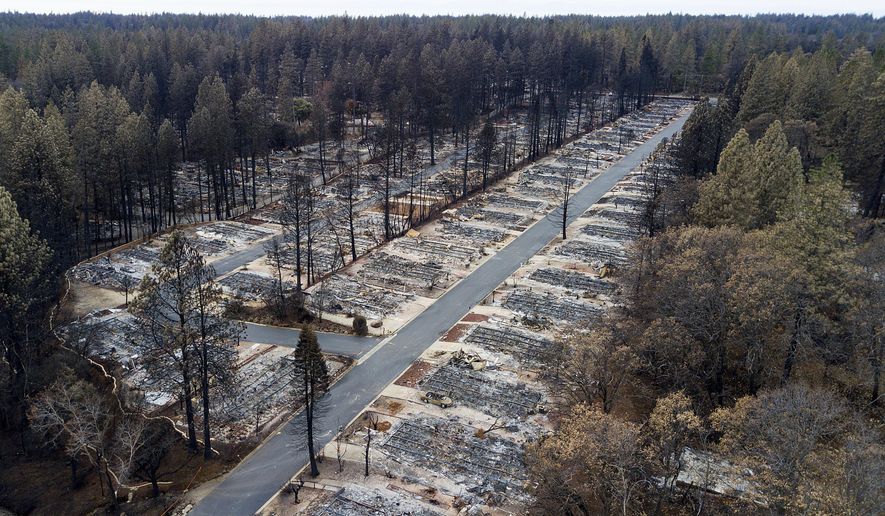 FILE - In this Dec. 3, 2018, file photo, homes leveled by the Camp Fire line the Ridgewood Mobile Home Park retirement community in Paradise, Calif. Attorneys say as many as 100,000 Californians are eligible to receive payments for the damages they've suffered from a series of devastating wildfires over the last several years, but tens of thousands of them have not. They face a Monday, Oct. 21, 2019, deadline to file claims against Pacific Gas & Electric, the utility blamed for many of the fires. (AP Photo/Noah Berger, File)