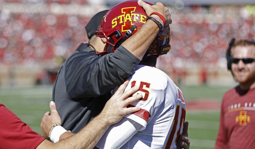 Iowa State coach Matt Campbell hugs Brock Purdy (15) after scoring a touchdown during the first half of an NCAA college football game against Texas Tech, Saturday, Oct. 19, 2019, in Lubbock, Texas. (Brad Tollefson/Lubbock Avalanche-Journal via AP)