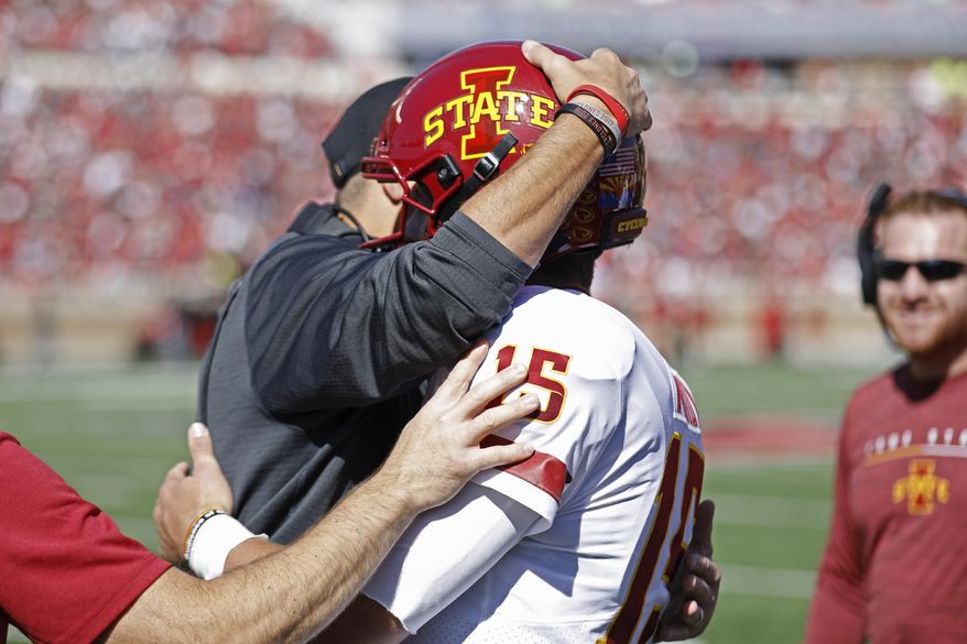 Iowa State coach Matt Campbell hugs Brock Purdy (15) after scoring a touchdown during the first half of an NCAA college football game against Texas Tech, Saturday, Oct. 19, 2019, in Lubbock, Texas. (Brad Tollefson/Lubbock Avalanche-Journal via AP)