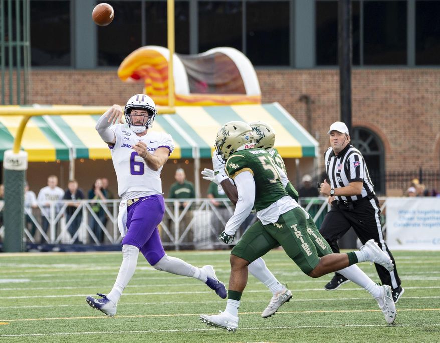 James Madison quarterback Ben DiNucci (6) is rushed out of the pocket by William & Mary linebackers Trey Watkins (50) and Atman Jones (21) during an NCAA college football game in Williamsburg, Va., on Saturday, Oct. 19, 2019. (Mike Caudill/The Virginian-Pilot via AP)