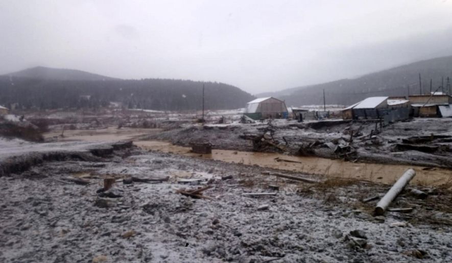 In this image made from video provided by Russian Emergency Situations Ministry press service, a view after the collapse during heavy rain occurred near the village of Shchetinkino, in the Krasnoyarsk region about 3,400 kilometers (2,100 miles) east of Moscow, Russia, Saturday, Oct. 19, 2019. Russian emergency officials say at least 15 people are dead after a dam at a Siberian gold mine collapsed and water flooded two workers' dormitories,13 people were unaccounted for, Russian news agencies reported. (Russian Ministry of Emergency Situations press service via AP)