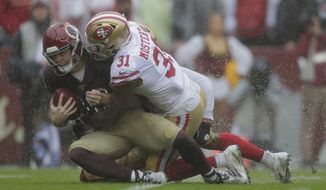 San Francisco 49ers running back Raheem Mostert, right, tackles Washington Redskins wide receiver Trey Quinn in the first half of an NFL football game, Sunday, Oct. 20, 2019, in Landover, Md. (AP Photo/Julio Cortez)