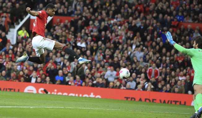 Manchester United&#x27;s Marcus Rashford scores his side&#x27;s opening goal during the English Premier League soccer match between Manchester United and Liverpool at the Old Trafford stadium in Manchester, England, Sunday, Oct. 20, 2019. (AP Photo/Jon Super)