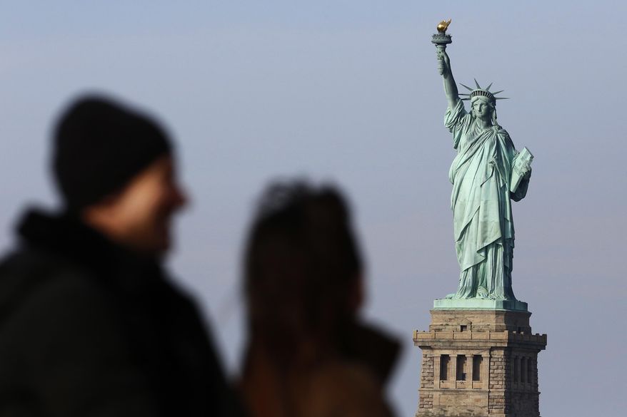 In this Jan. 21, 2018, photo, tourists ride the Staten Island Ferry to get a view of the Statue of Liberty in New York. A new poll from The Associated Press-NORC Center for Public Affairs Research shows majorities of Americans agree that diversity is a strength and that values such as constitutional rights, a fair judicial system and the American Dream are key to the nation’s identity. But the poll shows Americans are closely split over whether it’s better for immigrants to embrace a single U.S. culture or add their own variations to the mix. (AP Photo/Mark Lennihan) **FILE**