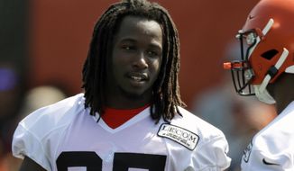 FILE - In this July 25, 2019, file photo, Cleveland Browns running back Kareem Hunt, left, talks with running back Nick Chubb during practice at the NFL football team&#39;s training camp facility, in Berea, Ohio.  Suspended Browns running back Hunt is practicing while serving the final two games of his NFL ban for two violent alterations. Hunt was on the field with teammates Monday, Oct. 21 for the first time since the end of training camp. (AP Photo/Tony Dejak, File)