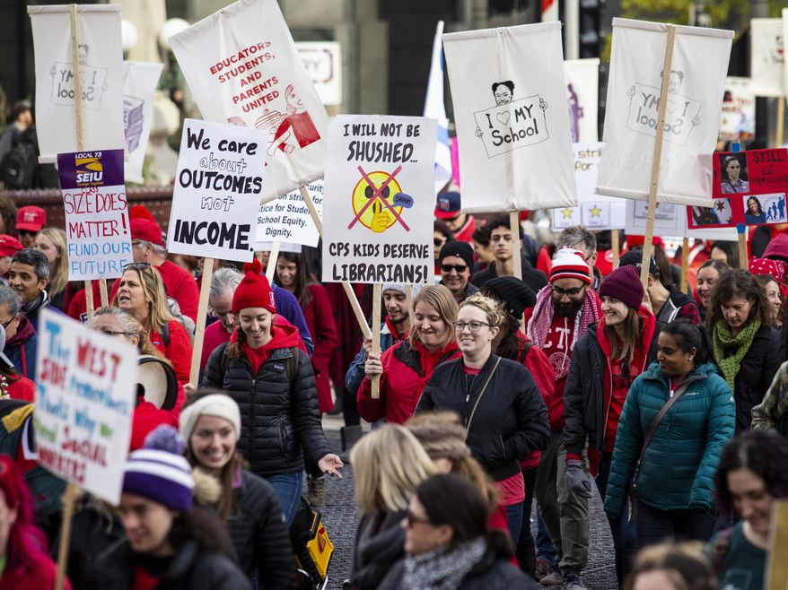 Thousands of Chicago Teachers Union members and their supporters march through the Loop on day two of a Chicago Public Schools district-wide strike, Friday, Oct. 18, 2019. (Ashlee Rezin Garcia/Chicago Sun-Times via AP)